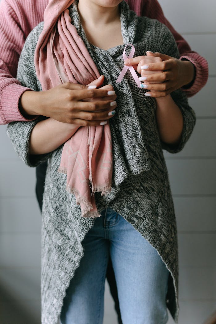 Woman in Pink and Gray Sweater and Blue Denim Jeans